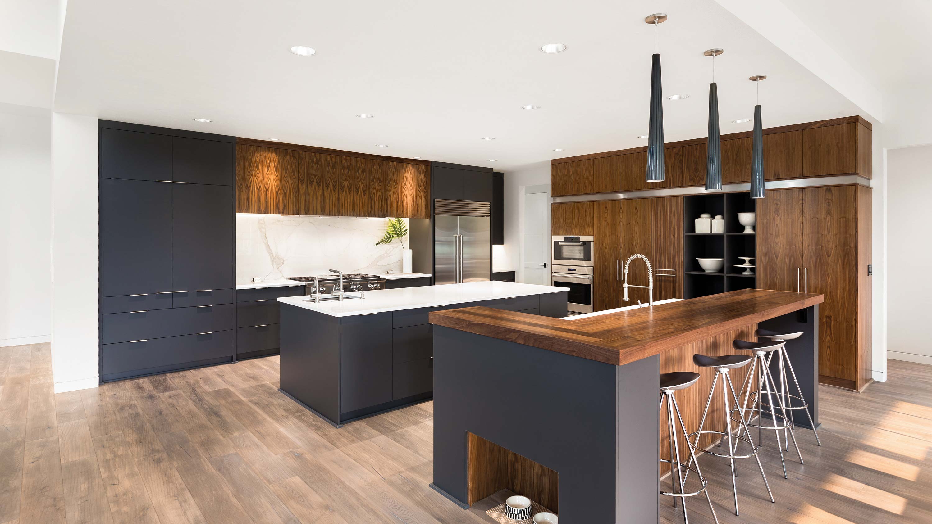 blue cabinets and wooden accents in a modern kitchen with Sonance technology