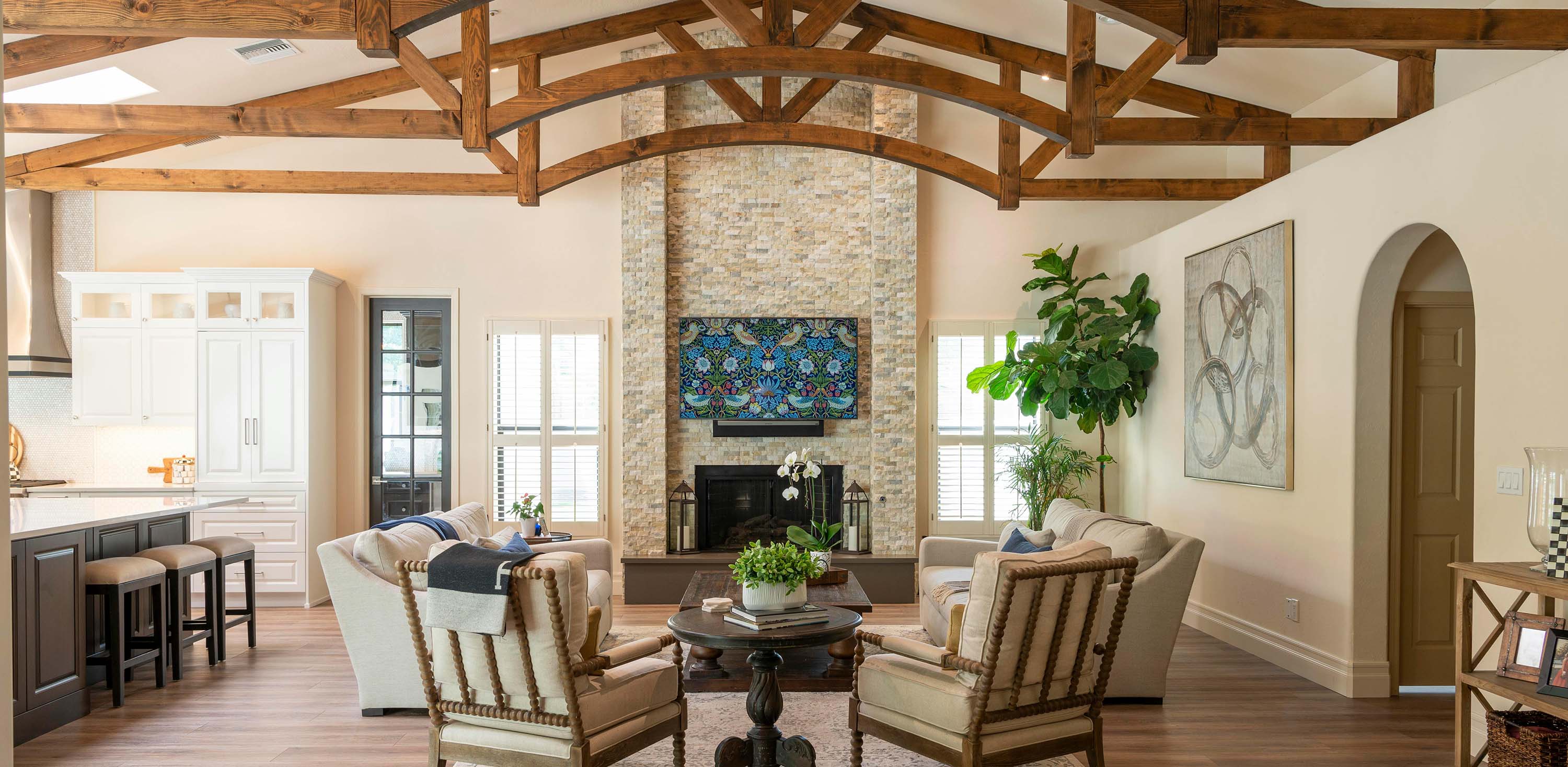 High-end southern style living room with exposed beams and large brick fireplace