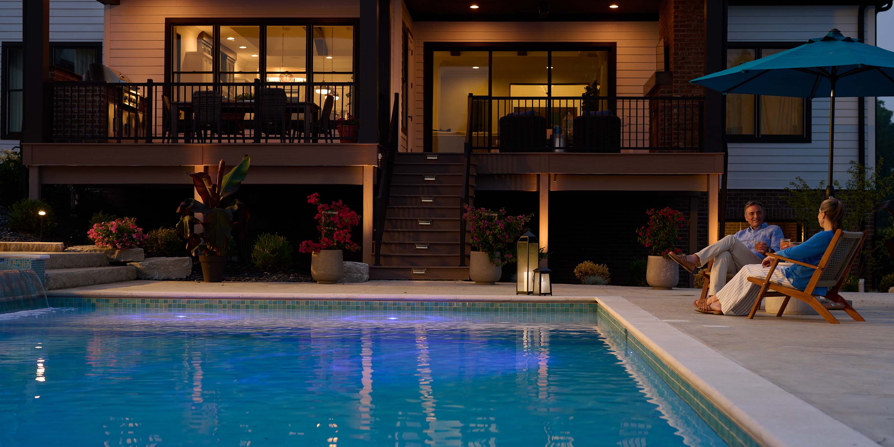 pool at dusk with outdoor lighting and jewel tones